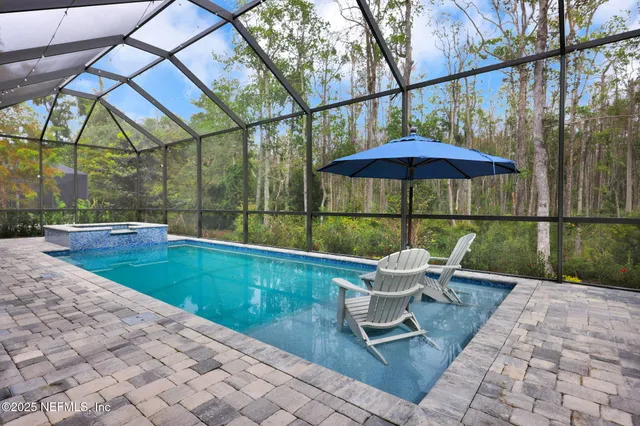 a view of a patio with a table chairs and a barbeque