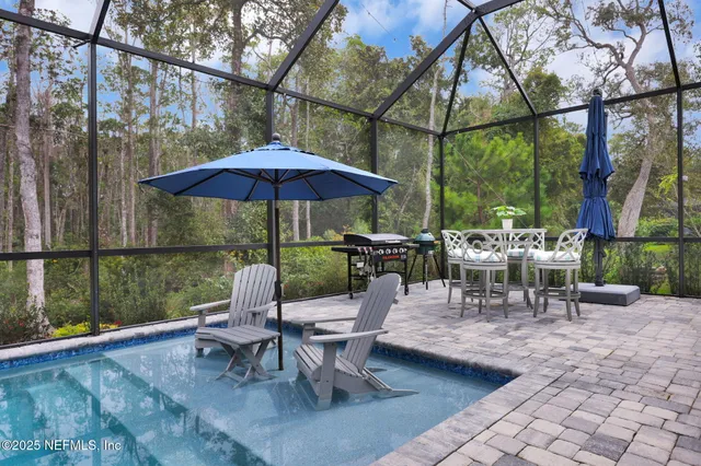 an aerial view of residential houses with outdoor space and parking