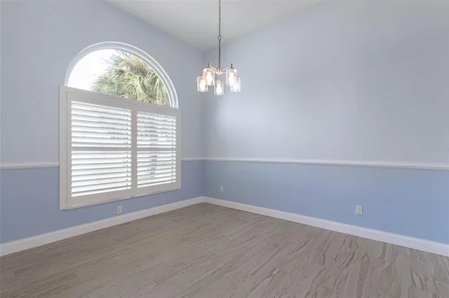 a spacious bathroom with bathtub a sink a window and mirror