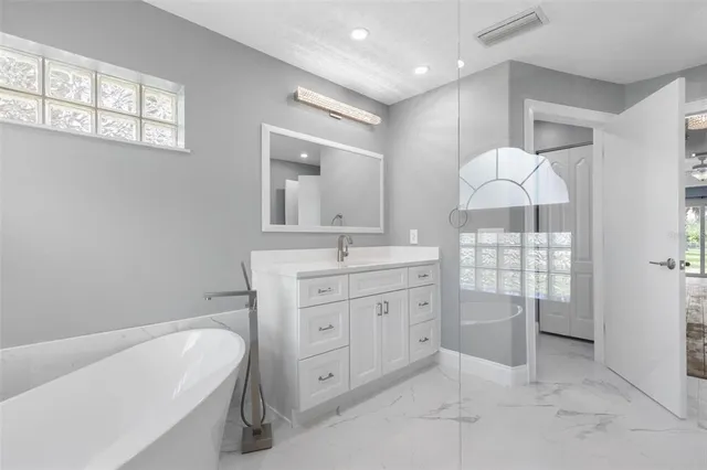 a white bath tub sitting in a bathroom