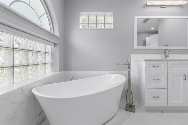 a white bath tub sitting in a bathroom