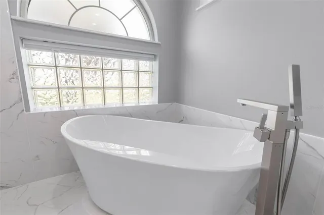 a bathroom with a sink vanity and bathtub