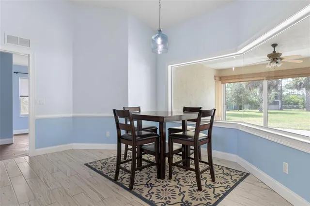 a view of a dining room with furniture window and outside view