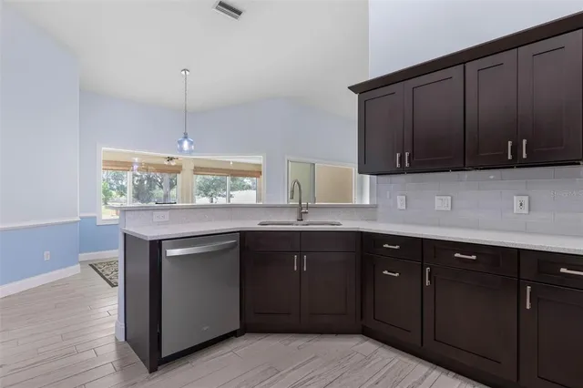 a kitchen with stainless steel appliances granite countertop wooden cabinets and sink