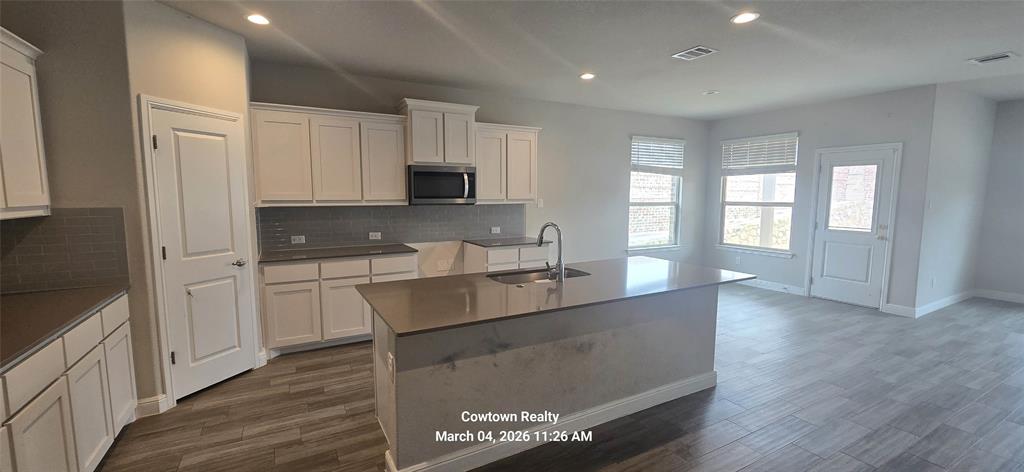 2340 Goodnight Ranch Drive Weatherford, TX 76087 - Photo 12 of 19 a kitchen with stainless steel appliances a refrigerator sink and cabinets