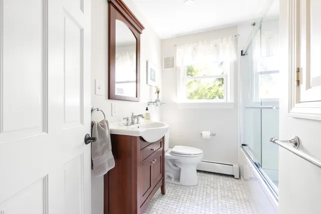 a bathroom with a toilet sink and mirror