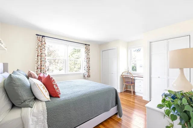 a bedroom with a bed lamp closet window and a rug