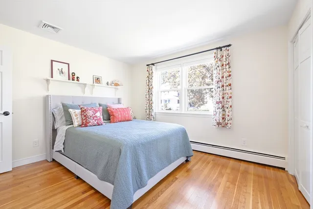 a bedroom with a large bed and a window