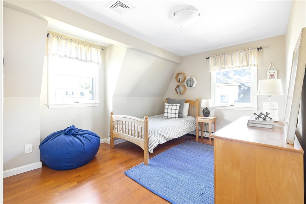 28 Cottage Street Natick, MA 01760 - Photo 17 of 32 a bedroom with a bed and a dresser