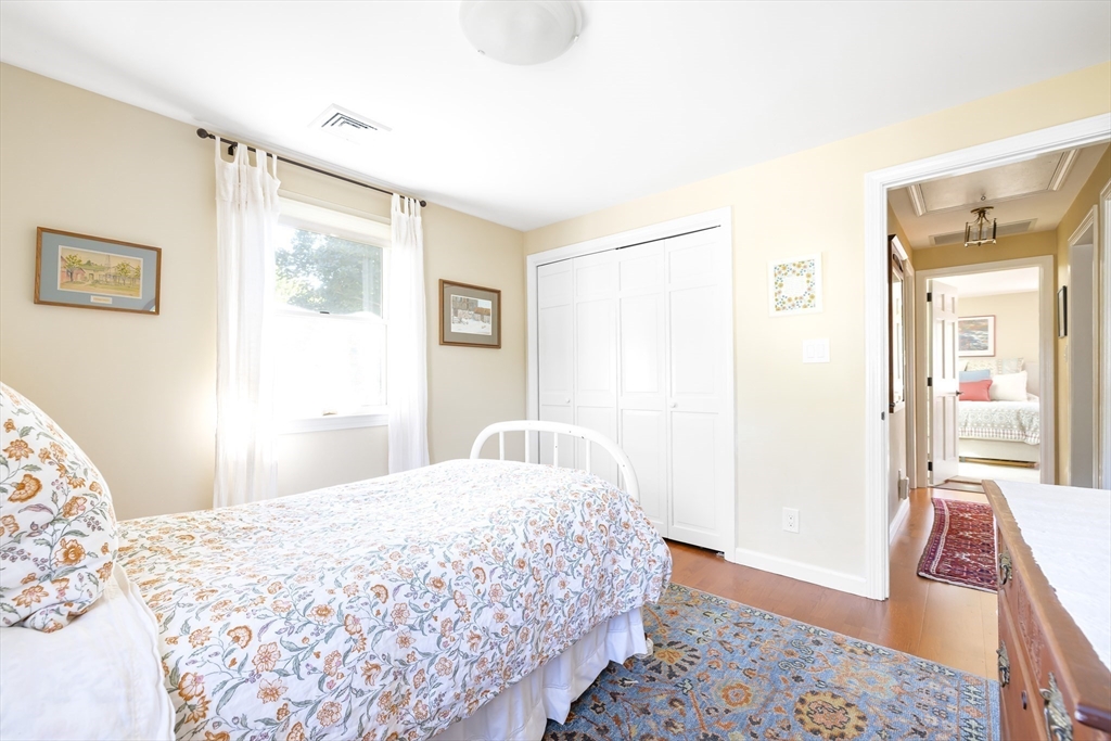 28 Cottage Street Natick, MA 01760 - Photo 19 of 32 a bedroom with a bed and wooden floor