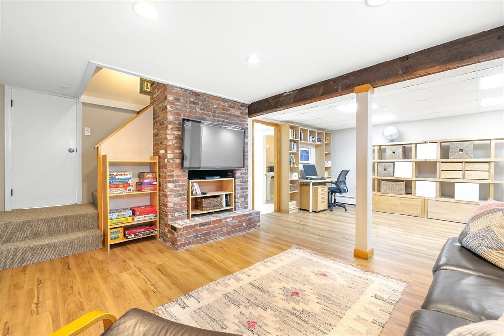 28 Cottage Street Natick, MA 01760 - Photo 22 of 32 a living room with furniture and a flat screen tv