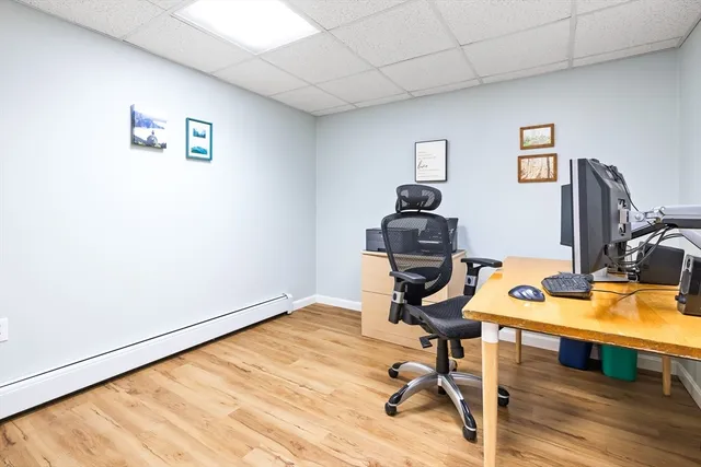 a view of a workspace with furniture and wooden floor
