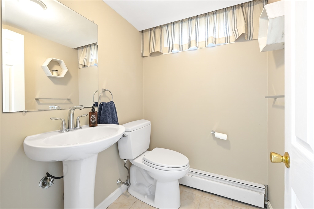 28 Cottage Street Natick, MA 01760 - Photo 26 of 32 a bathroom with a sink a toilet and mirror