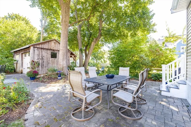 a view of a chairs and table in backyard