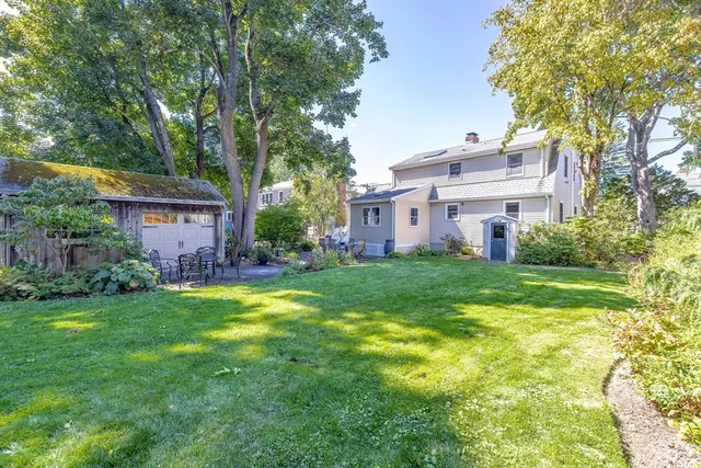 a view of a house with a big yard and large trees