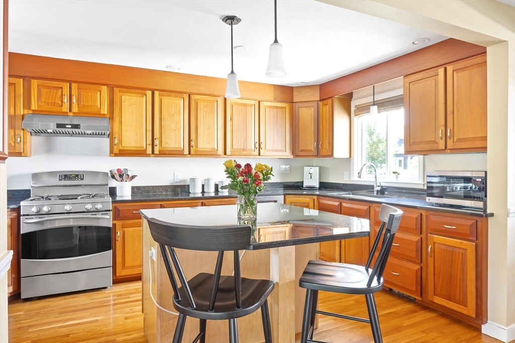 28 Cottage Street Natick, MA 01760 - Photo 6 of 32 a kitchen with stainless steel appliances granite countertop a stove a sink and a refrigerator