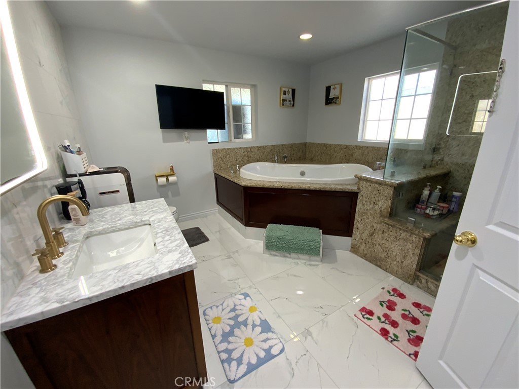 4131 Rowland Avenue El Monte, CA 91731 - Photo 16 of 22 a bathroom with a sink toilet and mirror