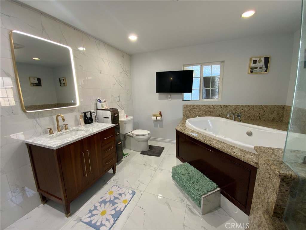 4131 Rowland Avenue El Monte, CA 91731 - Photo 17 of 22 a spacious bathroom with a double vanity sink and mirror