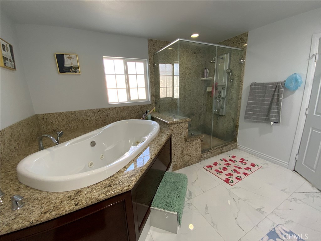 4131 Rowland Avenue El Monte, CA 91731 - Photo 18 of 22 a bathroom with a granite countertop sink a toilet and shower