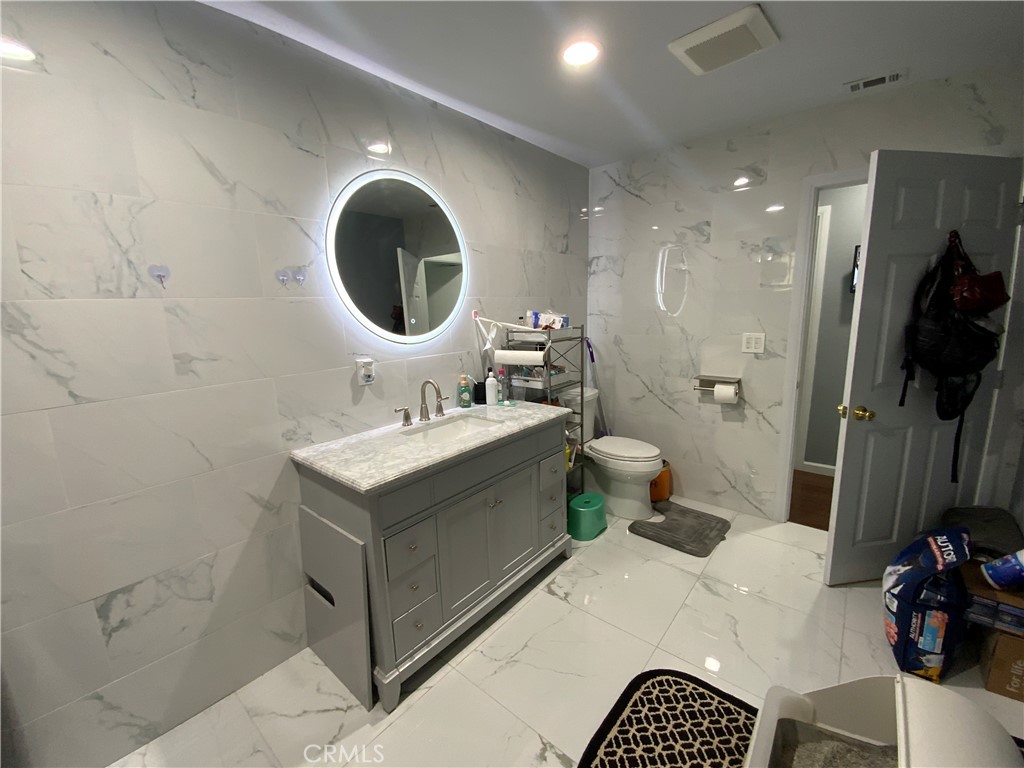 4131 Rowland Avenue El Monte, CA 91731 - Photo 10 of 22 a bathroom with a sink toilet and mirror