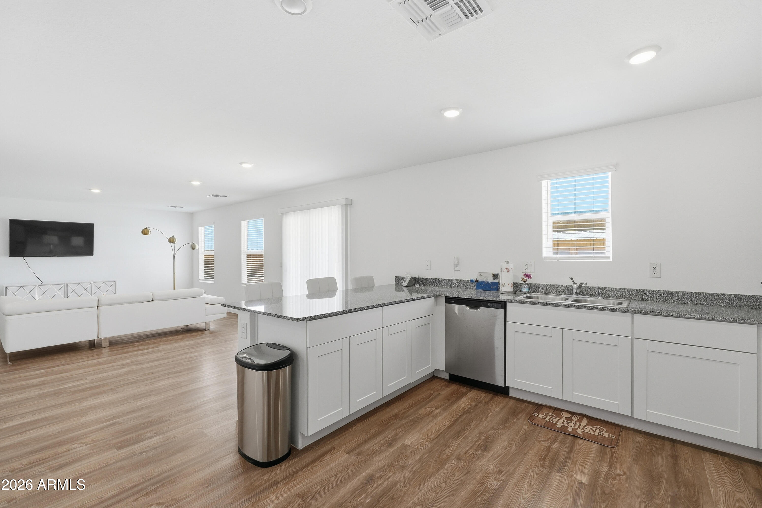 15610 South Moon Valley Road Arizona City, AZ 85123 - Photo 13 of 36 a kitchen with sink cabinets and wooden floor