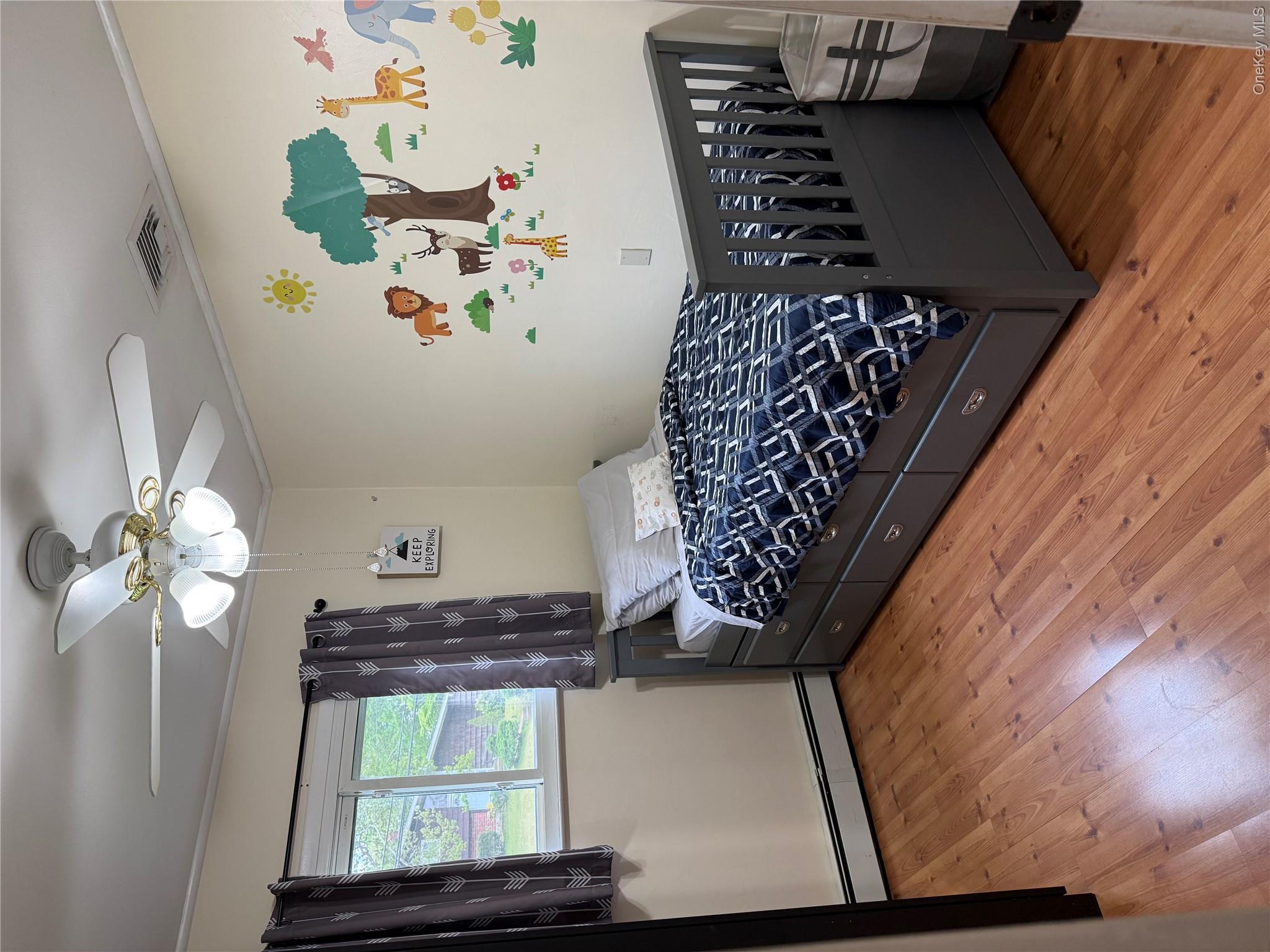 161 Hawkins Road Centereach, NY 11720 - Photo 11 of 16 a bedroom with a bed and a window