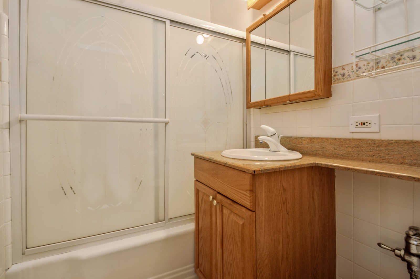 1585 Ridge Avenue, Unit 302 Evanston, IL 60201 - Photo 11 of 21 a bathroom with a sink and mirror