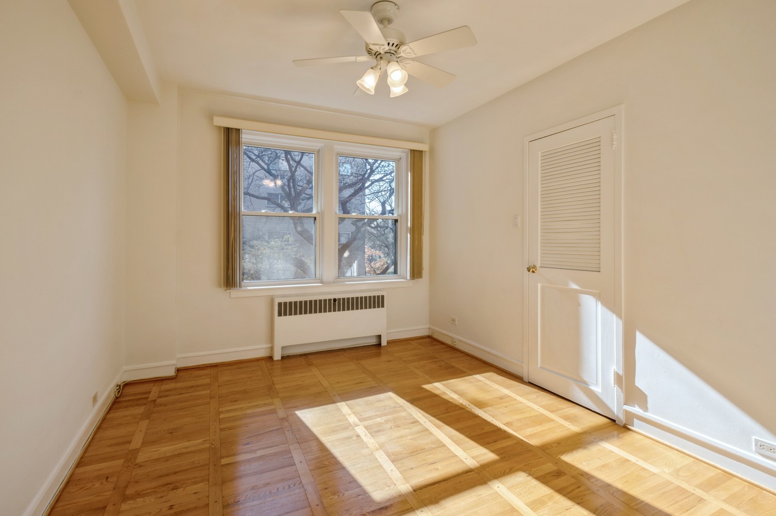 1585 Ridge Avenue, Unit 302 Evanston, IL 60201 - Photo 12 of 21 a view of an empty room with a window and wooden floor