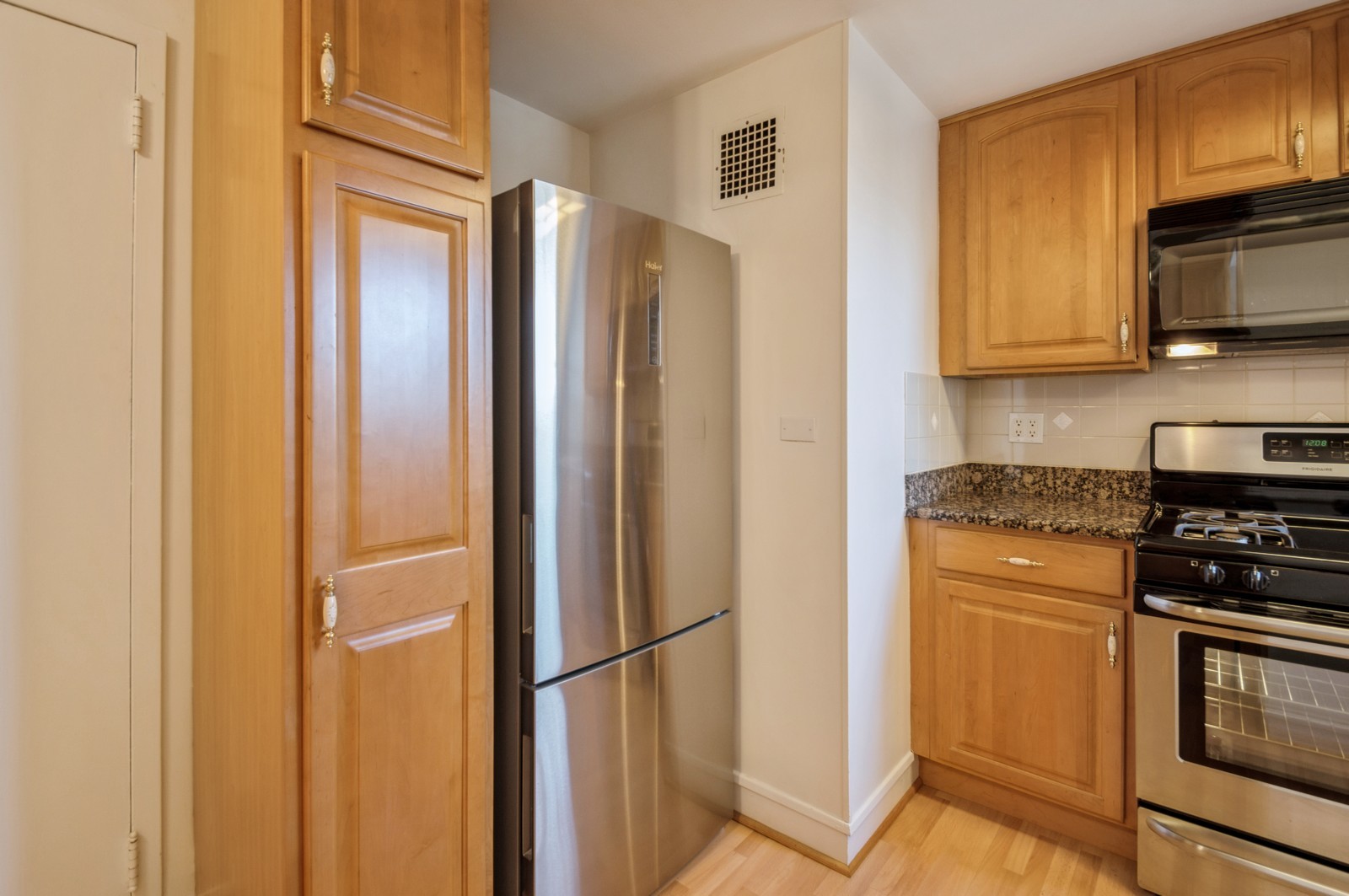 1585 Ridge Avenue, Unit 302 Evanston, IL 60201 - Photo 7 of 21 a kitchen with stainless steel appliances granite countertop a refrigerator stove and microwave