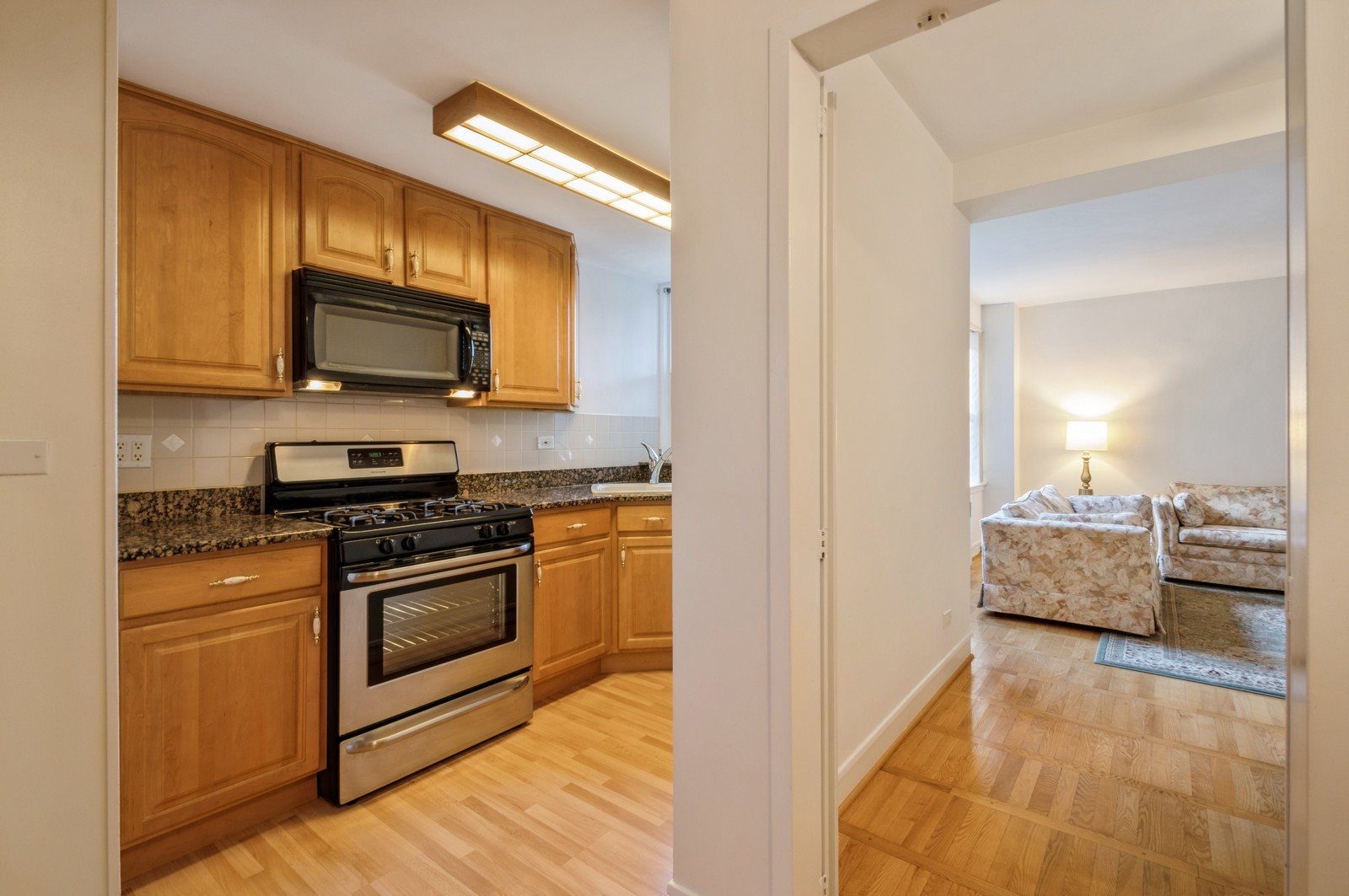 1585 Ridge Avenue, Unit 302 Evanston, IL 60201 - Photo 8 of 21 a kitchen with stainless steel appliances a stove a microwave and cabinets