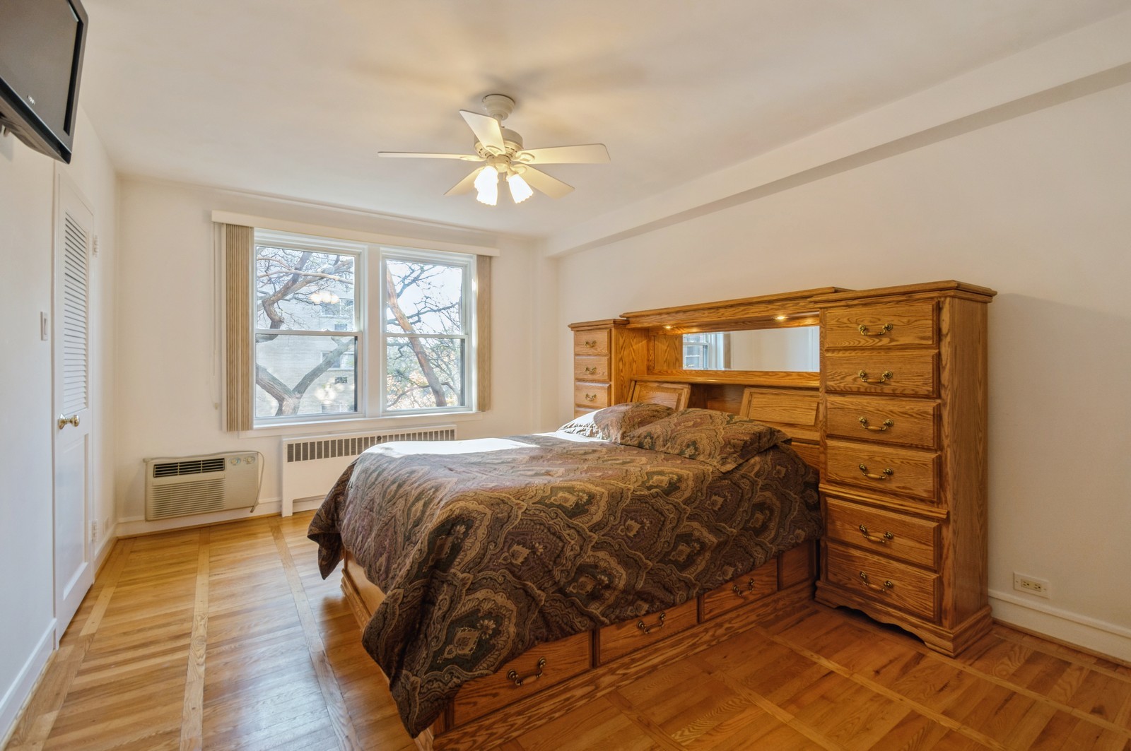 1585 Ridge Avenue, Unit 302 Evanston, IL 60201 - Photo 9 of 21 a bedroom with a bed a dresser and next to a window