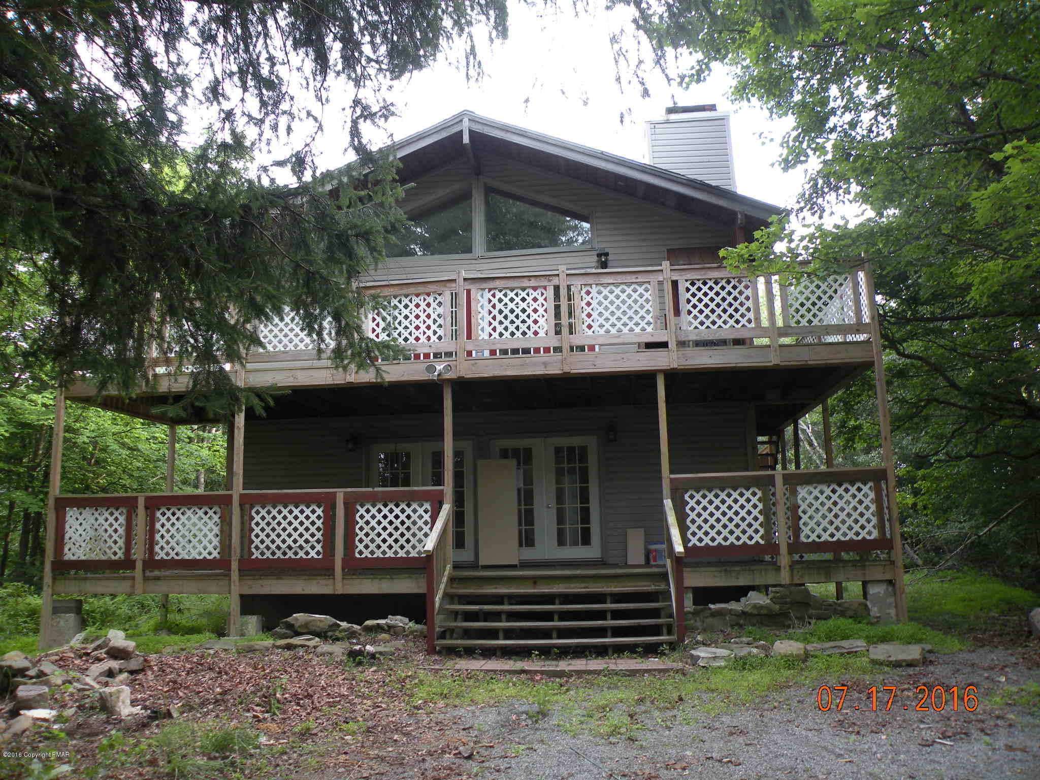 1096 Clover Road South Long Pond, PA 18334 - Photo 1 of 15 a front view of a house with garden