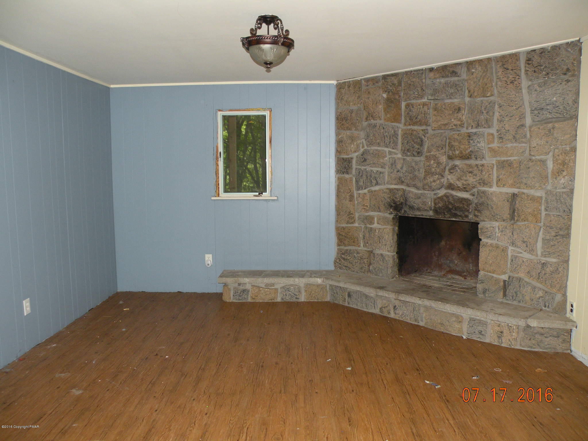 1096 Clover Road South Long Pond, PA 18334 - Photo 2 of 15 an empty room with a fireplace