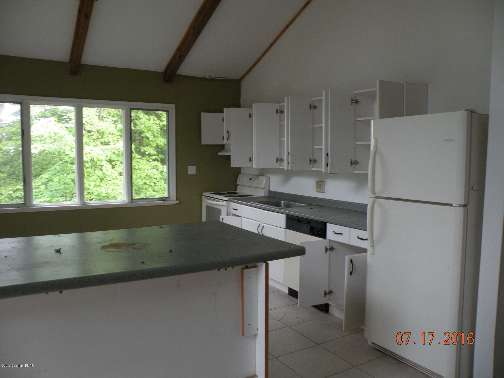 1096 Clover Road South Long Pond, PA 18334 - Photo 9 of 15 a kitchen with a sink a refrigerator and window