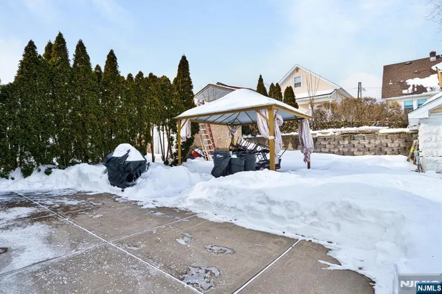 a man sitting on a bench in the middle of a yard