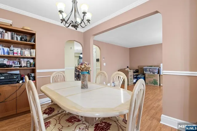 a dining room with furniture and chandelier