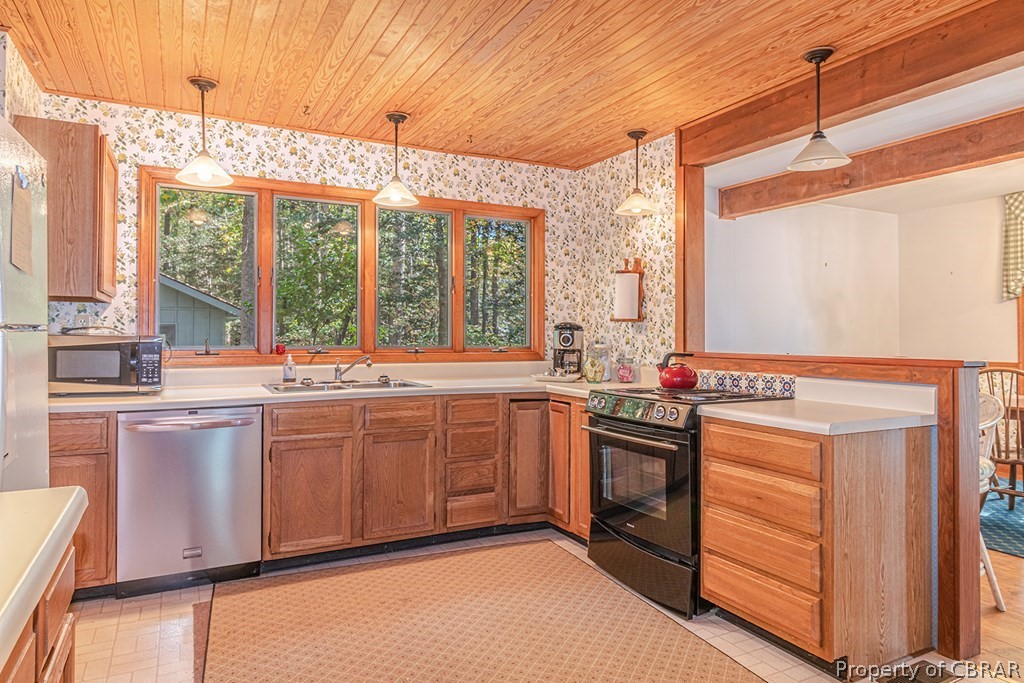 131 Ewell Road Lancaster, VA 22503 - Photo 28 of 50 a kitchen with stainless steel appliances granite countertop a stove and a refrigerator