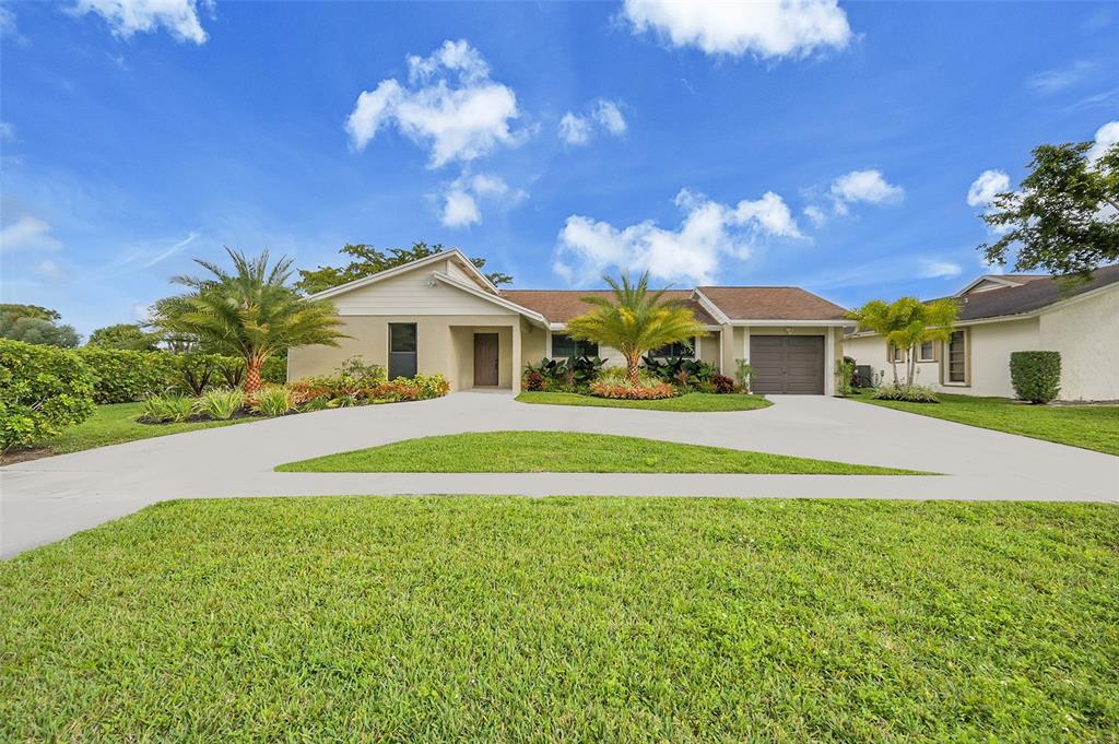 6195 Winding Brook Way Delray Beach, FL 33484 - Photo 1 of 68 a front view of a house with a yard