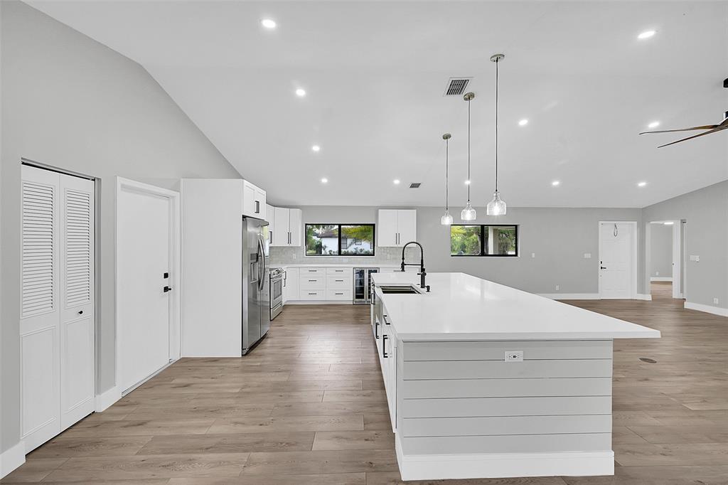 6195 Winding Brook Way Delray Beach, FL 33484 - Photo 16 of 68 a large white kitchen with a large refrigerator oven and white cabinets