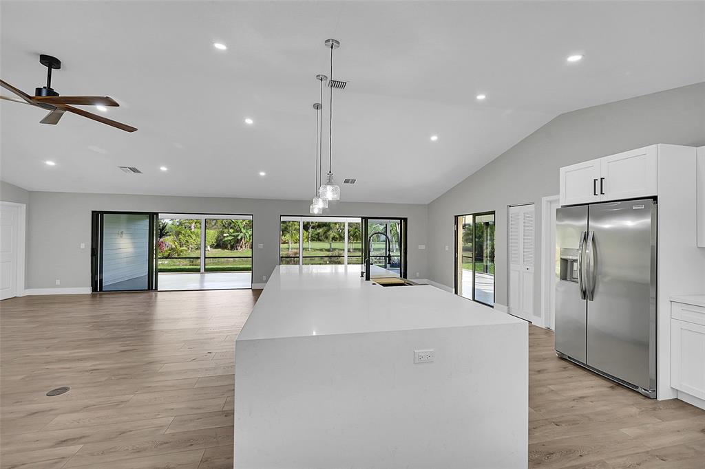 6195 Winding Brook Way Delray Beach, FL 33484 - Photo 20 of 68 a large kitchen with sink and refrigerator