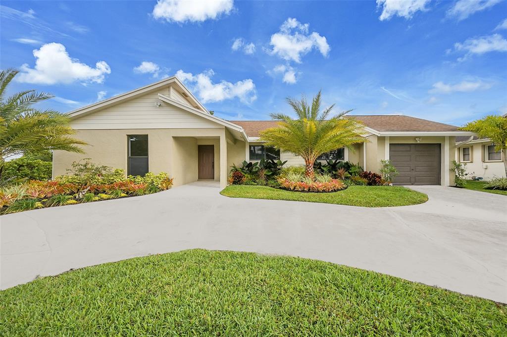 6195 Winding Brook Way Delray Beach, FL 33484 - Photo 2 of 68 a view of a house with a yard and potted plants