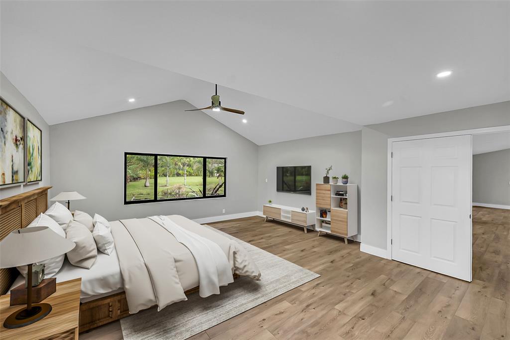 6195 Winding Brook Way Delray Beach, FL 33484 - Photo 24 of 68 a bedroom with a bed and wooden floor