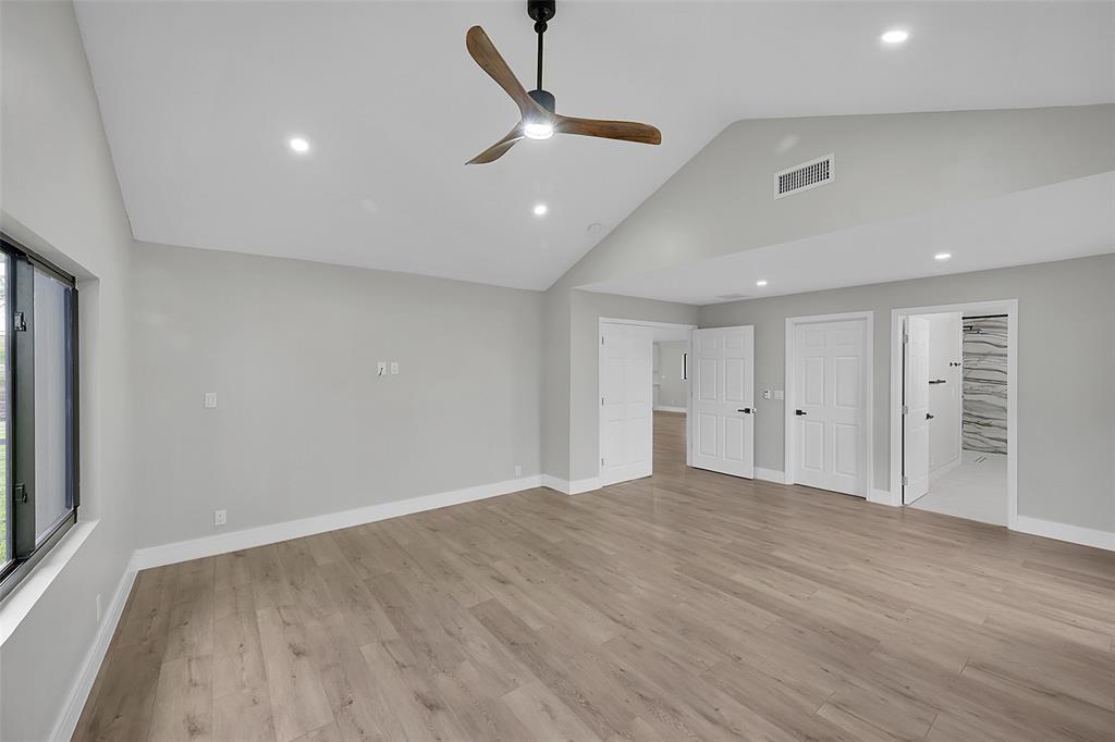 6195 Winding Brook Way Delray Beach, FL 33484 - Photo 25 of 68 a view of an empty room with wooden floor and a ceiling fan