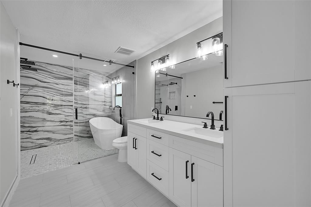 6195 Winding Brook Way Delray Beach, FL 33484 - Photo 29 of 68 a spacious bathroom with a double vanity sink toilet and shower