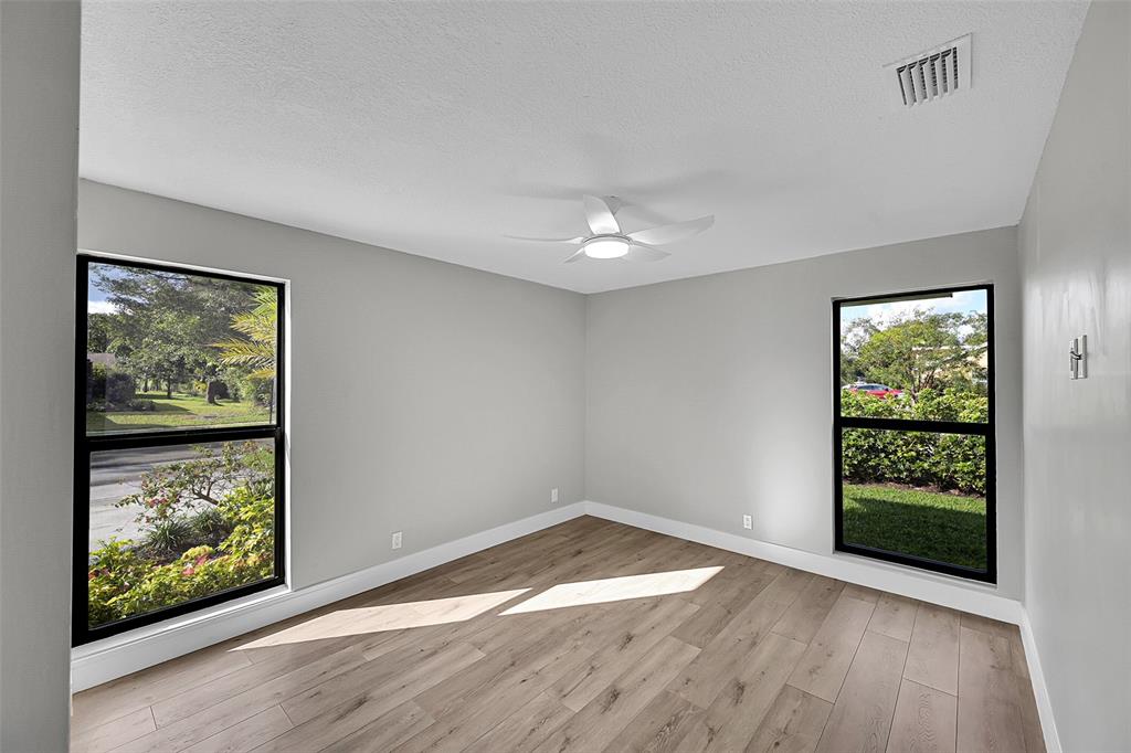 6195 Winding Brook Way Delray Beach, FL 33484 - Photo 31 of 68 an empty room with wooden floor and windows