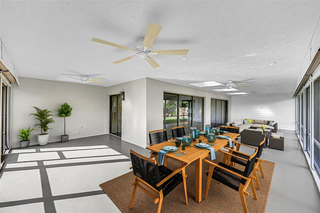 6195 Winding Brook Way Delray Beach, FL 33484 - Photo 38 of 68 a living room with furniture a chandelier and a dining table