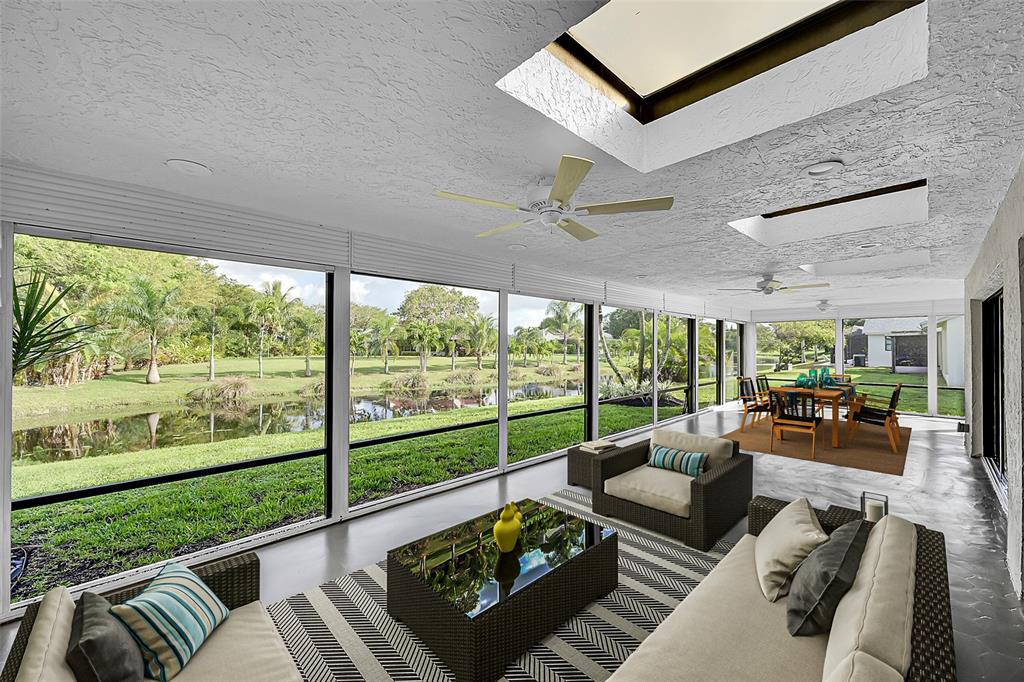 6195 Winding Brook Way Delray Beach, FL 33484 - Photo 40 of 68 a living room with furniture and a large window