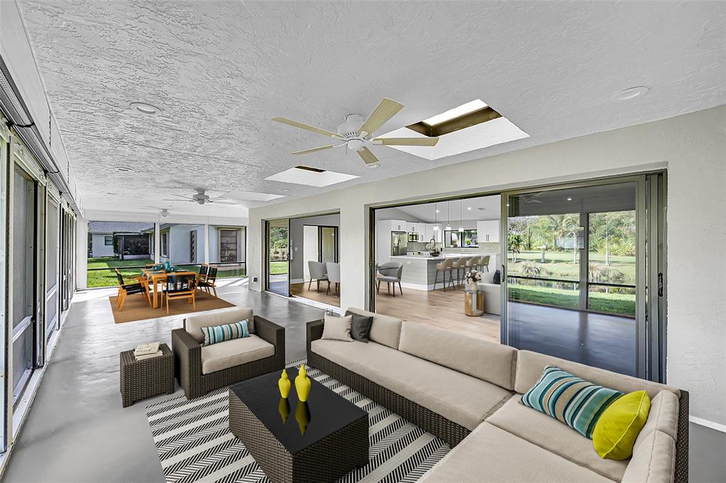 6195 Winding Brook Way Delray Beach, FL 33484 - Photo 42 of 68 a living room with furniture and a large window