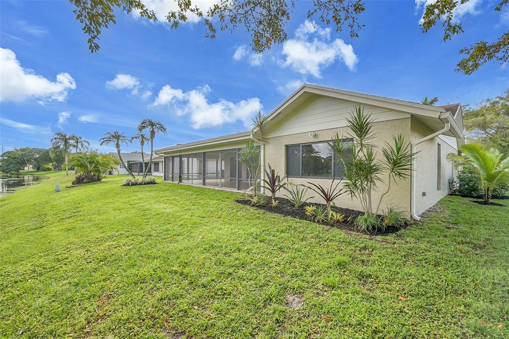 6195 Winding Brook Way Delray Beach, FL 33484 - Photo 49 of 68 a front view of a house with garden