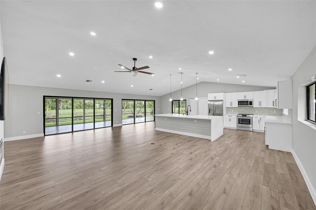 6195 Winding Brook Way Delray Beach, FL 33484 - Photo 5 of 68 a view of an empty room with wooden floor and a window